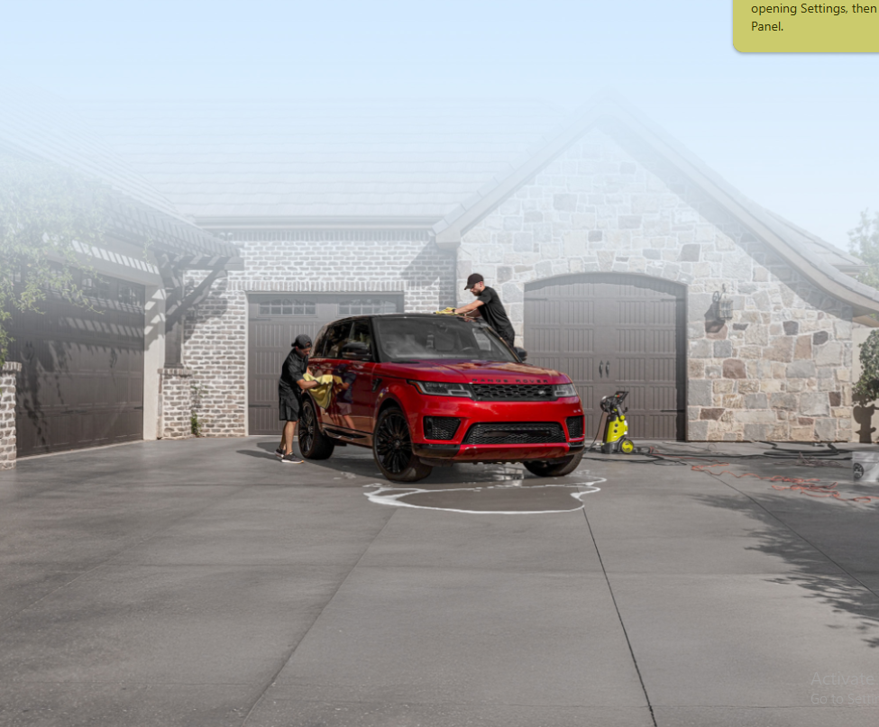 Slick Whips detailing a red Range Rover in a driveway