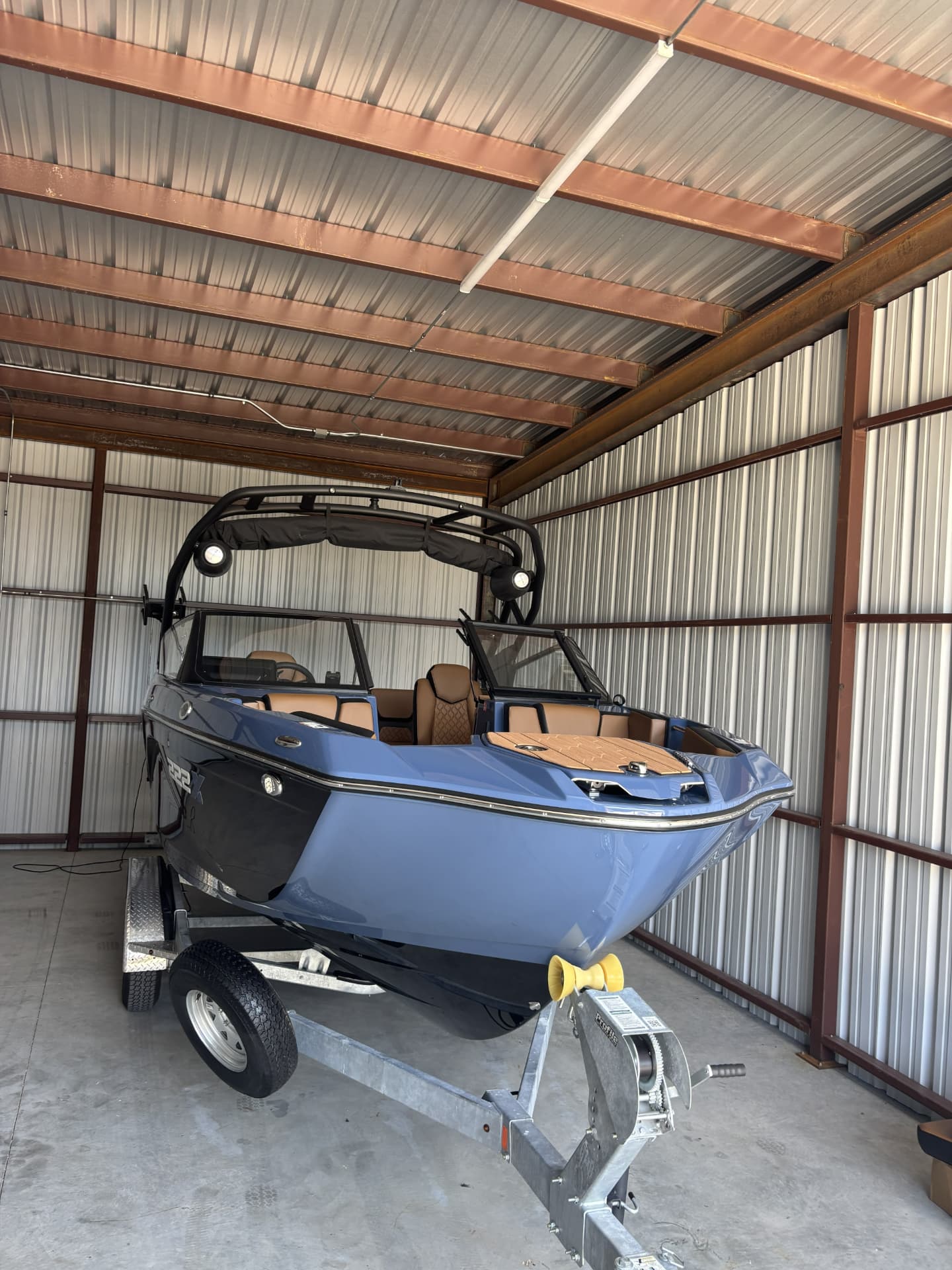 Detailed ski boat cleaned and protected in its storage barn